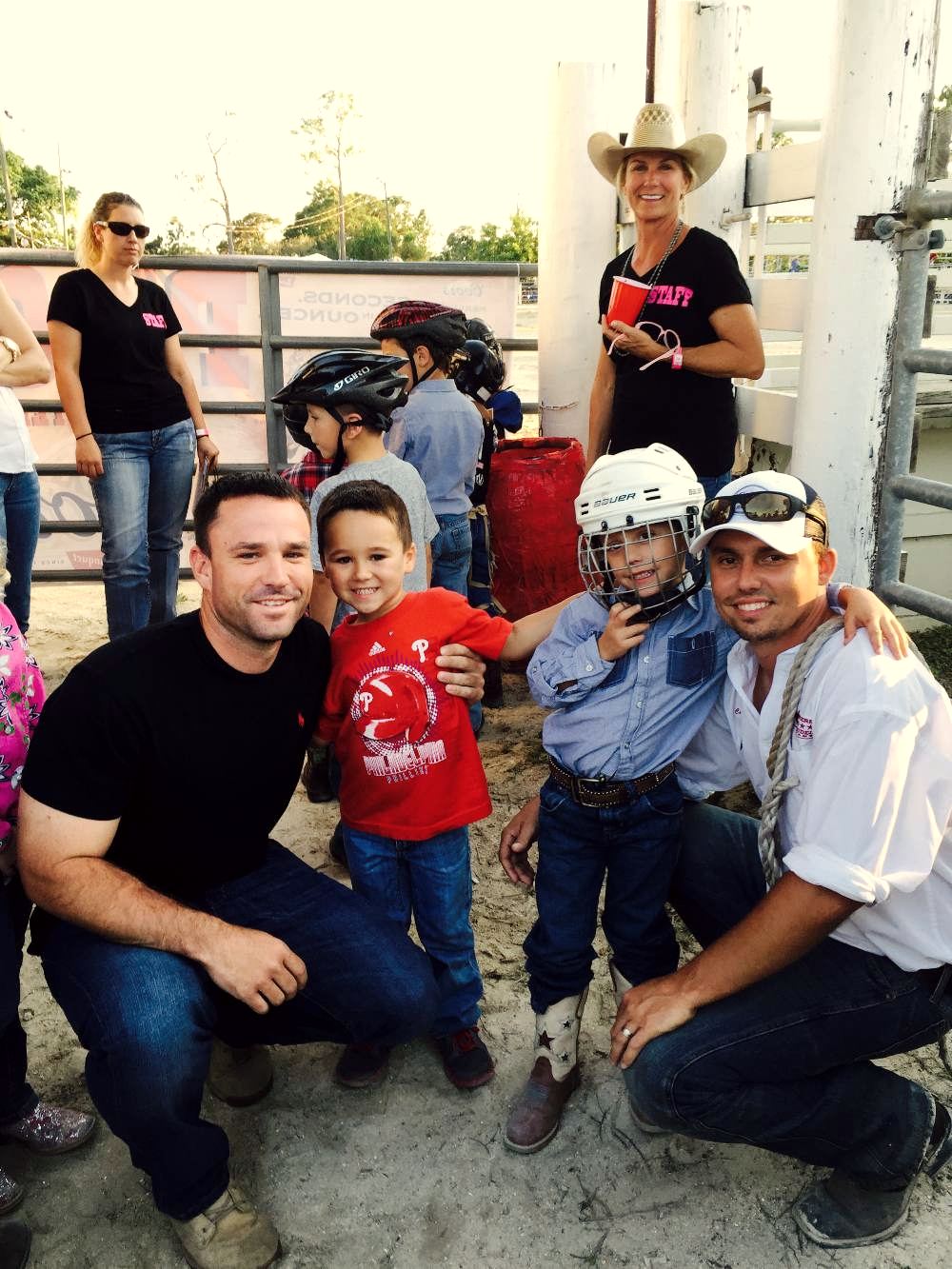Families with young children smiling together at the arena